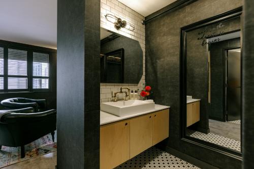 a bathroom with a sink and a mirror at The Anndore House, part of JDV by Hyatt in Toronto