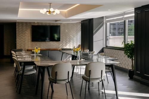 a dining room with a table and chairs at The Anndore House, part of JDV by Hyatt in Toronto