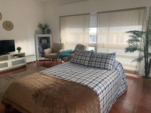 a bedroom with a bed and a living room at Beach and Surf Lovers in Costa da Caparica