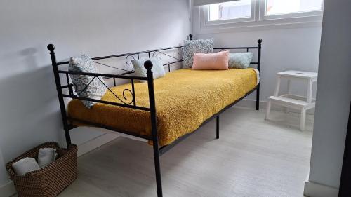 a bedroom with a black bed with yellow sheets and pillows at Esperanza 5 in Lebrija
