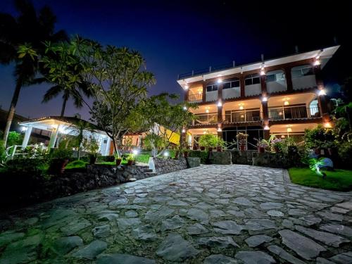 a hotel at night with a stone path in front of it at Hotel Villas Ema in Zihuatanejo