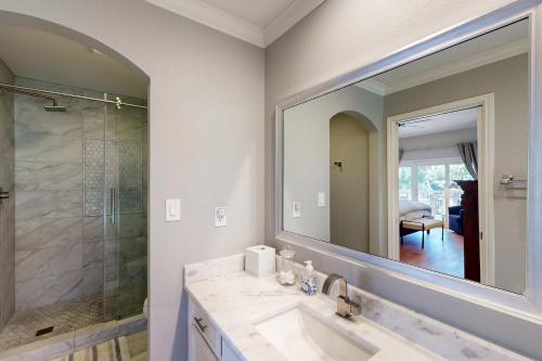 a bathroom with a sink and a large mirror at Bay Point Paradise in Horseshoe Bay