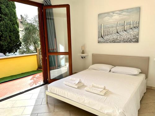 a bedroom with a bed and a large window at WONDERLUST HOUSE in Suvereto