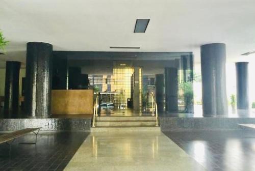 a building with a lobby with columns and a door at Ed Celestino Rocha-Coração da Cidade in Belém