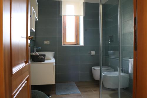a bathroom with a toilet and a glass shower at Anna’s Home in Pompei