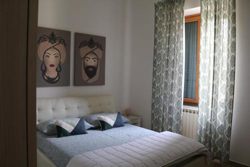 Anna’s Home في بومباي: غرفة نوم بسرير مع صورتين على الحائط