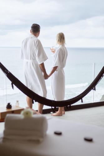 a man and woman standing in front of a mirror at Hotel Basalto in Punta Mita