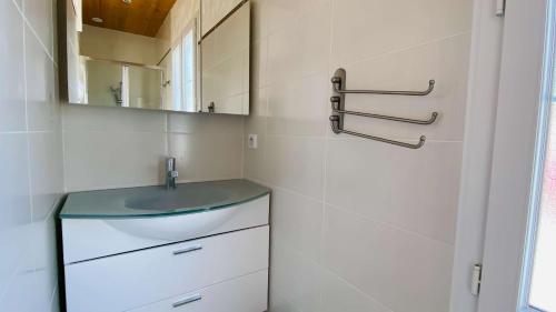 a bathroom with a sink and a mirror at Charmante villa à proximité de la plage du Petit Sergent in Le Bois-Plage-en-Ré