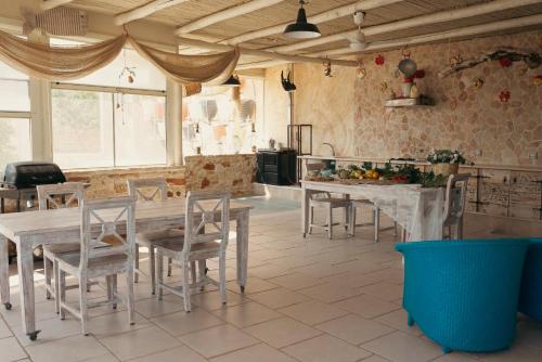 a kitchen with a table and chairs in a room at Il Trullo al Mare -Trullo by the sea- Pool & Beach in Molfetta