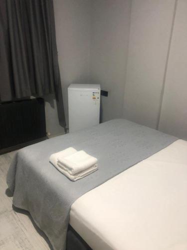 a room with two beds and a refrigerator at GDL OTEL in Samsun