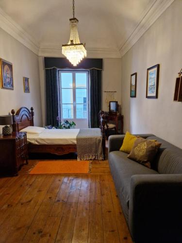 a living room with a couch and a bed at Mont' Sobro House in Évora