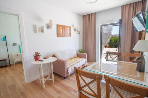 a living room with a table and a couch at Quinta da Pitarrela in Peso da Régua
