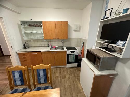 a kitchen with a sink and a stove top oven at Sonja Holiday Home in Jáma Jindřich