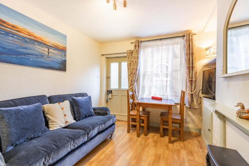 a living room with a couch and a table at Fishermans Cottage - Norfolk Holiday Properties in Cromer