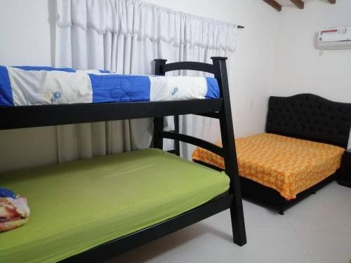 Cette chambre comprend 2 lits superposés et une chaise. dans l'établissement Casa Campestre con piscina, à San Jerónimo