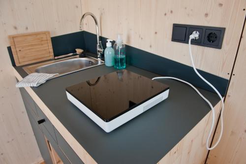 a kitchen with a counter with a sink and a sink at Friesland Glamping Camp Schortens in Schortens