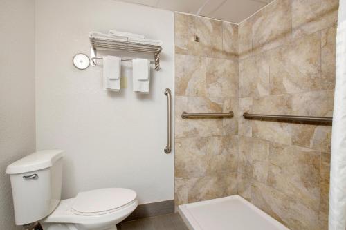 a bathroom with a toilet and a shower at Quality Inn Newton at I-80 in Newton