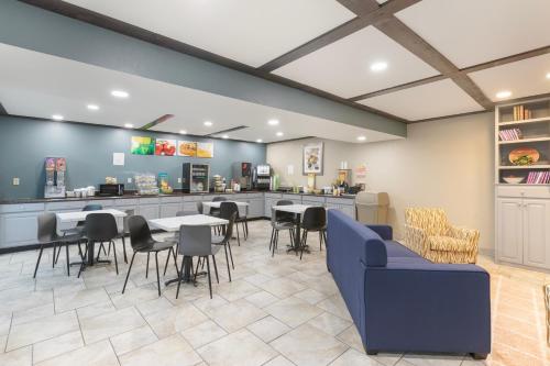 a restaurant with tables and chairs and a counter at Quality Inn Newton at I-80 in Newton