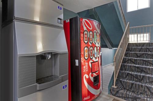 a coca cola vending machine next to a staircase at Quality Inn Newton at I-80 in Newton