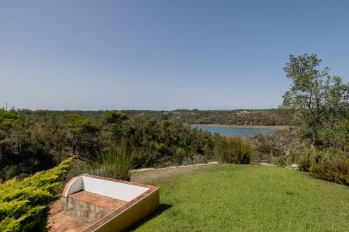 a bath tub sitting on top of a field of grass at RIVERSIDE RANCH by Nature Bliss in Vila Nova de Milfontes