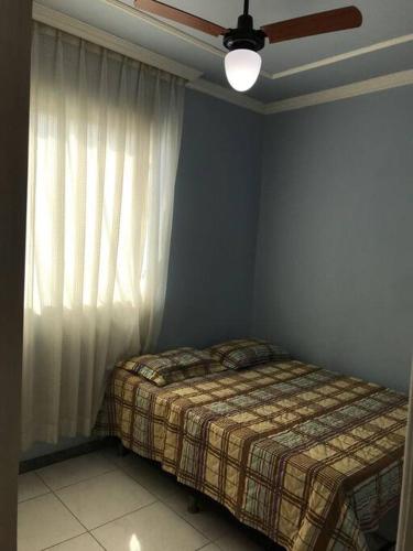a bedroom with a bed next to a window at Casa confortável p/13/14/18 pessoas c 4/5/6 suítes in Belo Horizonte