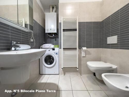 a bathroom with a sink and a washing machine at 3V Apartments Bardolino in Bardolino