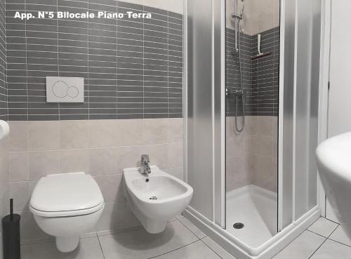 a bathroom with a shower and a toilet and a sink at 3V Apartments Bardolino in Bardolino
