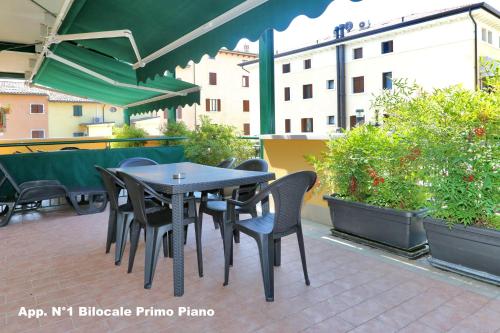 a table and chairs sitting on a patio at 3V Apartments Bardolino in Bardolino