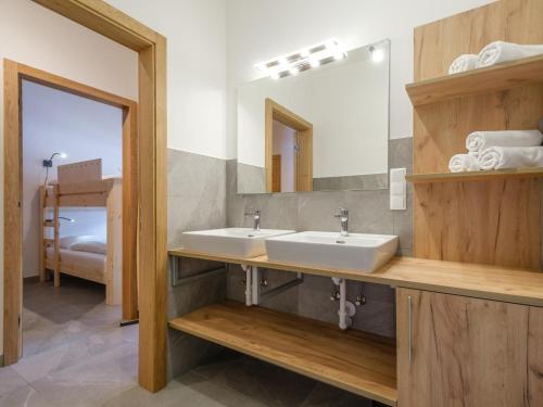 a bathroom with two sinks and a mirror at Kreischberg The Exclusive 9 in Sankt Lorenzen ob Murau