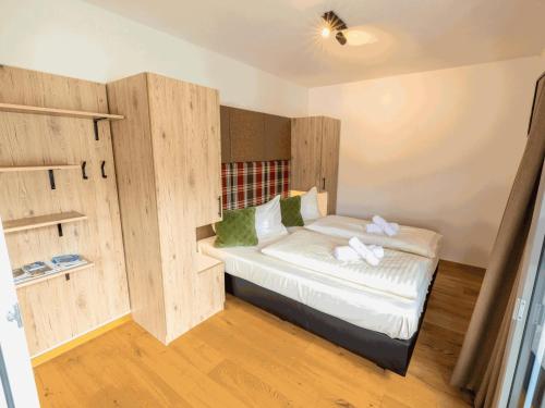 a small room with a bed with wooden walls at Kreischberg The Exclusive 3 in Sankt Lorenzen ob Murau