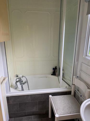 a bathroom with a bath tub and a sink at Monks Heath fold mobile home in Macclesfield