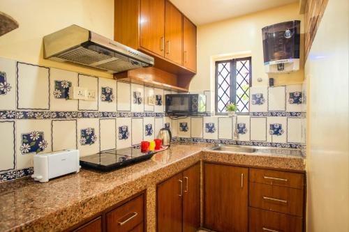 a kitchen with a sink and a counter top at 'Golden Sunset' 3bhk beach villa in Benaulim