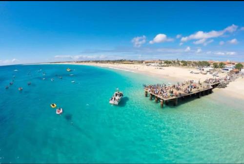a group of people on a dock in the water at Apartamento T2 equipado Vila Verde in Santa Maria