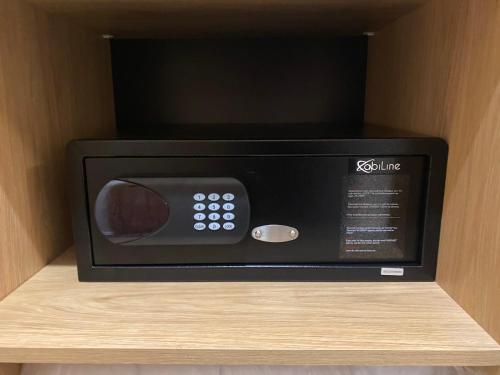 a microwave oven sitting on top of a shelf at Apartment FRIENDs Besenova - free pool in Bešeňová