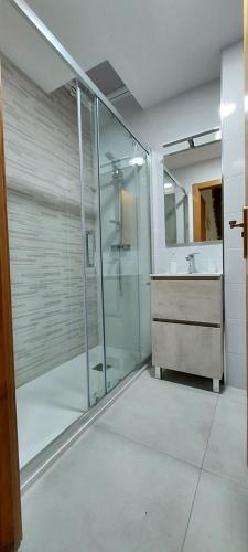 a bathroom with a glass shower and a sink at Bungalow Iratxe en Santa Pola in Santa Pola