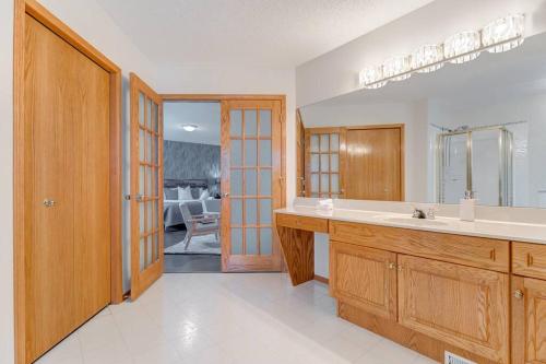 a bathroom with a sink and a mirror at Coral Springs Lakefront Retreat in Calgary