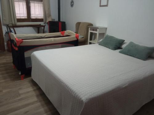 two beds sitting in a room with at SAN ISIDRO in Migueláñez