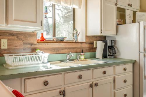 a kitchen with a sink and a refrigerator at The Chamberlain Chalet in Angel Fire