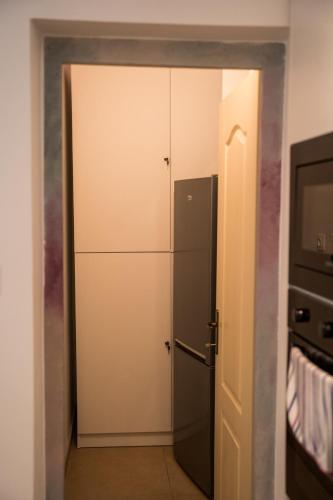 a door to a kitchen with a refrigerator at Csipesz_Vendégház in Sümeg