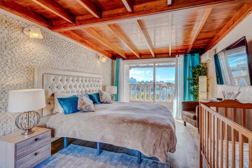 a bedroom with a large bed and a balcony at Residencia El Duque - 1, VILLA MARIUS in Adeje