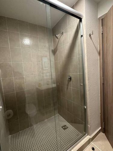 a shower with a glass door in a bathroom at Casa AMAR i LLA 3 Lagos - Centrica in Guadalajara