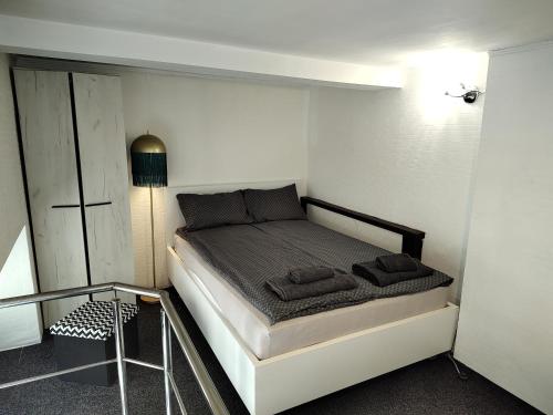 a small bedroom with a bed in a room at elefant in Baia Mare