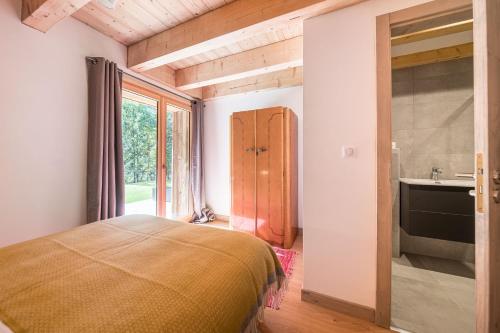 a bedroom with a bed and a bathroom with a sink at Le Refuge Au Pied d'Hauto in Montriond
