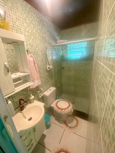 W łazience znajduje się prysznic, toaleta i umywalka. w obiekcie Casa da Clau w mieście Cananéia
