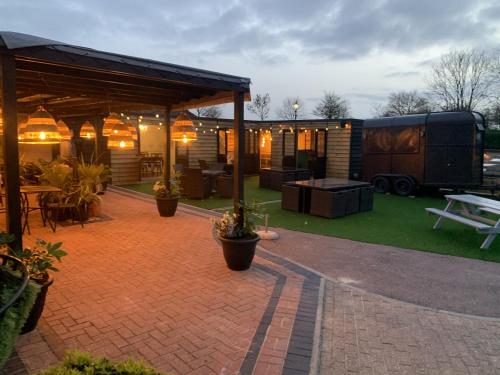 a patio with a tent and a table and a trailer at The Old Red Lion Inn in Cambridge