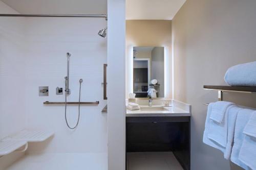 a bathroom with a sink and a shower at TownePlace Suites by Marriott Dallas DFW Airport North/Irving in Irving