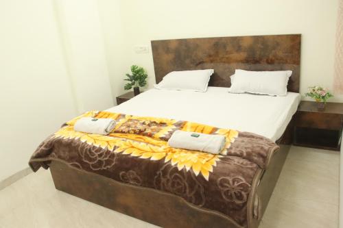 a bedroom with a large bed with a wooden headboard at Hotel Taj Bi Plaza in Aurangabad