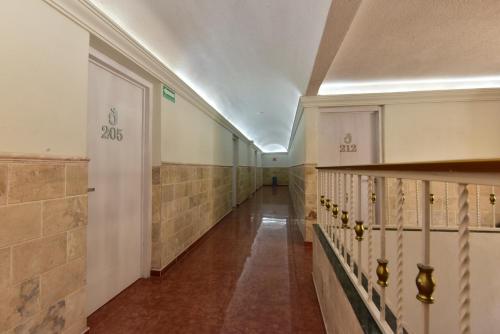 a hallway of a building with a long corridor at Bed Bed Hotel Abasolo in Torreón