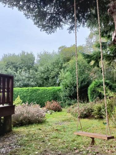 a swing in a yard with a garden at 299 Willow Lodge in Trawsfynydd