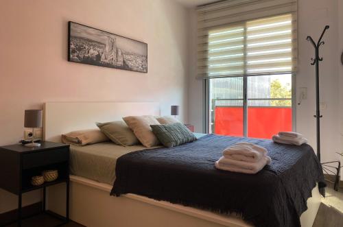 a bedroom with a bed with towels on it at Barcelona Beach Breeze in Barcelona